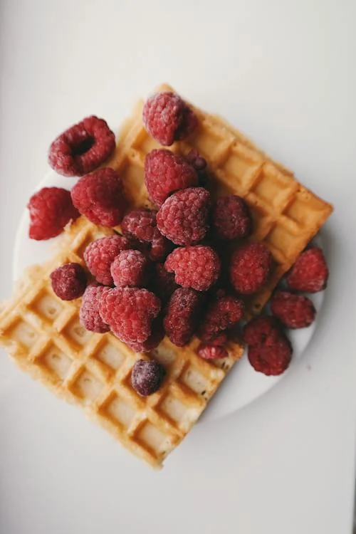 close-up of a Belgian waffle, maple syrup