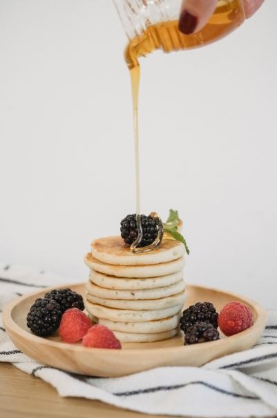 Pouring on stack of pancakes