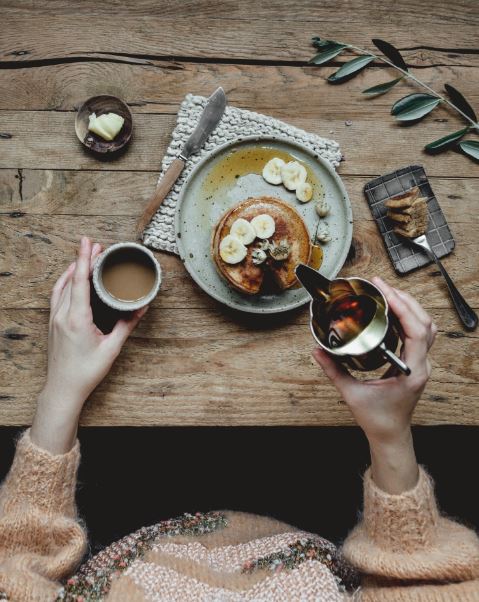 Pouring syrup on pancakes