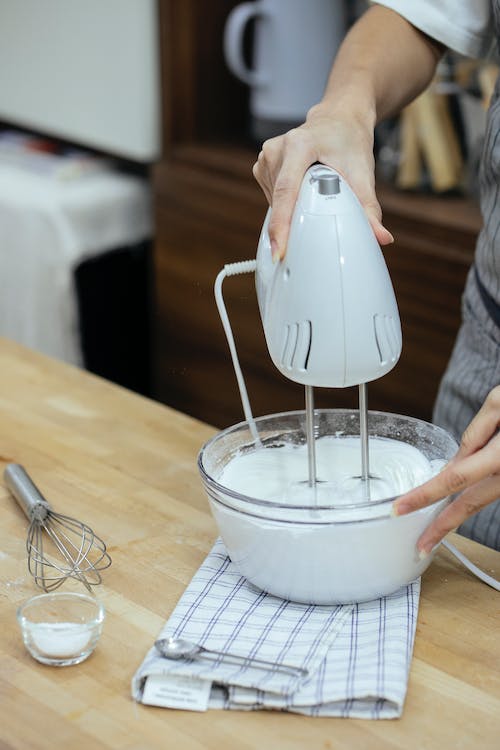 Person using hand mixer