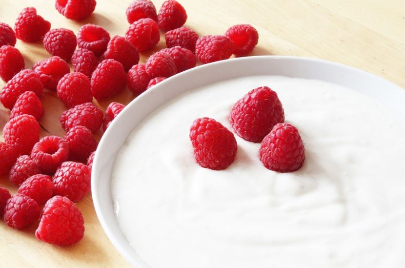 a bowl of yogurt with raspberries, raspberries