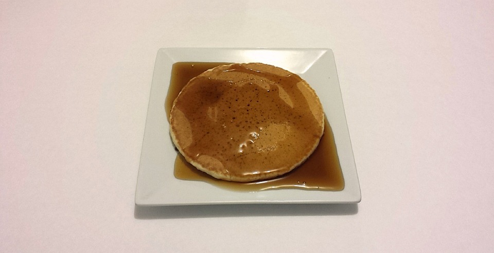 a plate of pancake with maple syrup