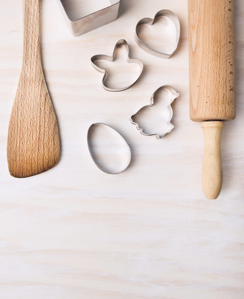 kitchen bake utensils with easter cookie cutters, top view